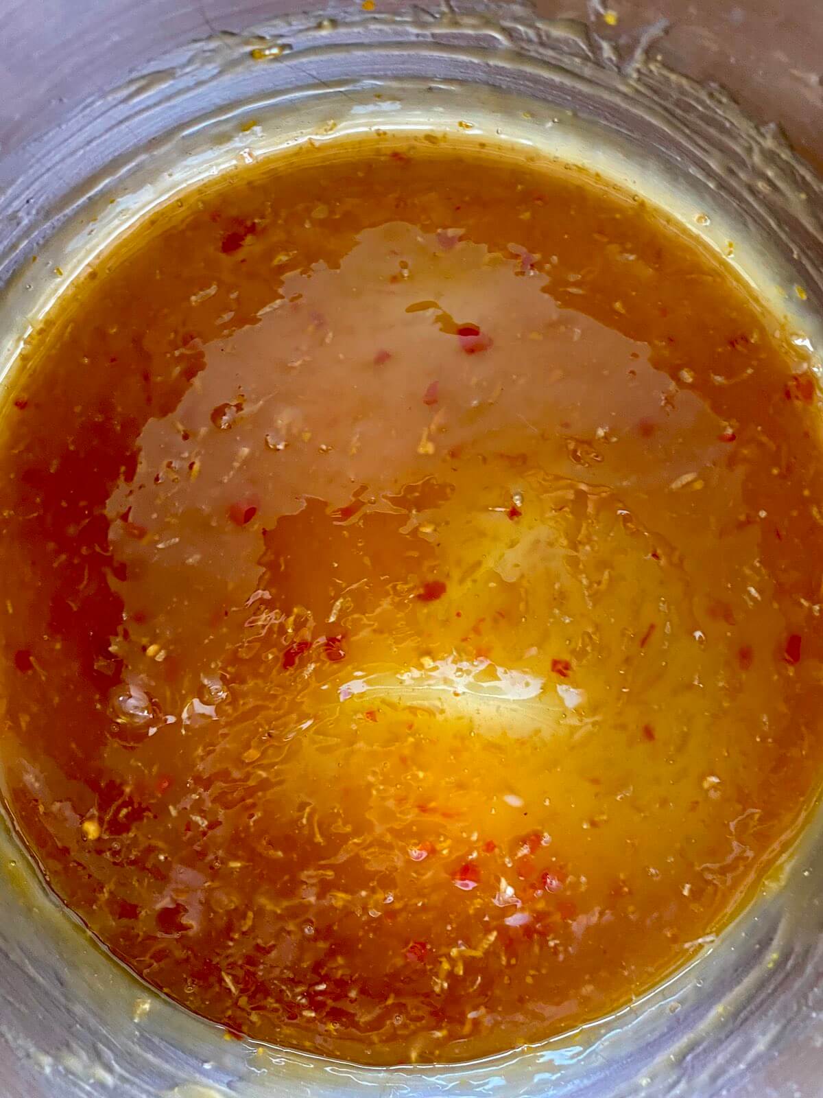 Orange sauce simmering in a saucepan.