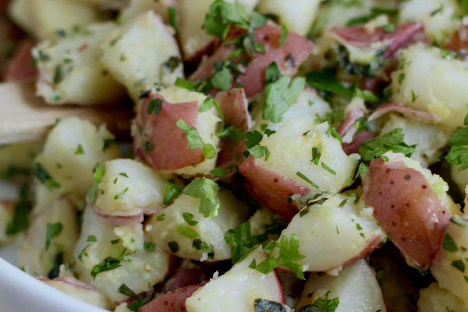 Herbed potato salad in a white bowl.