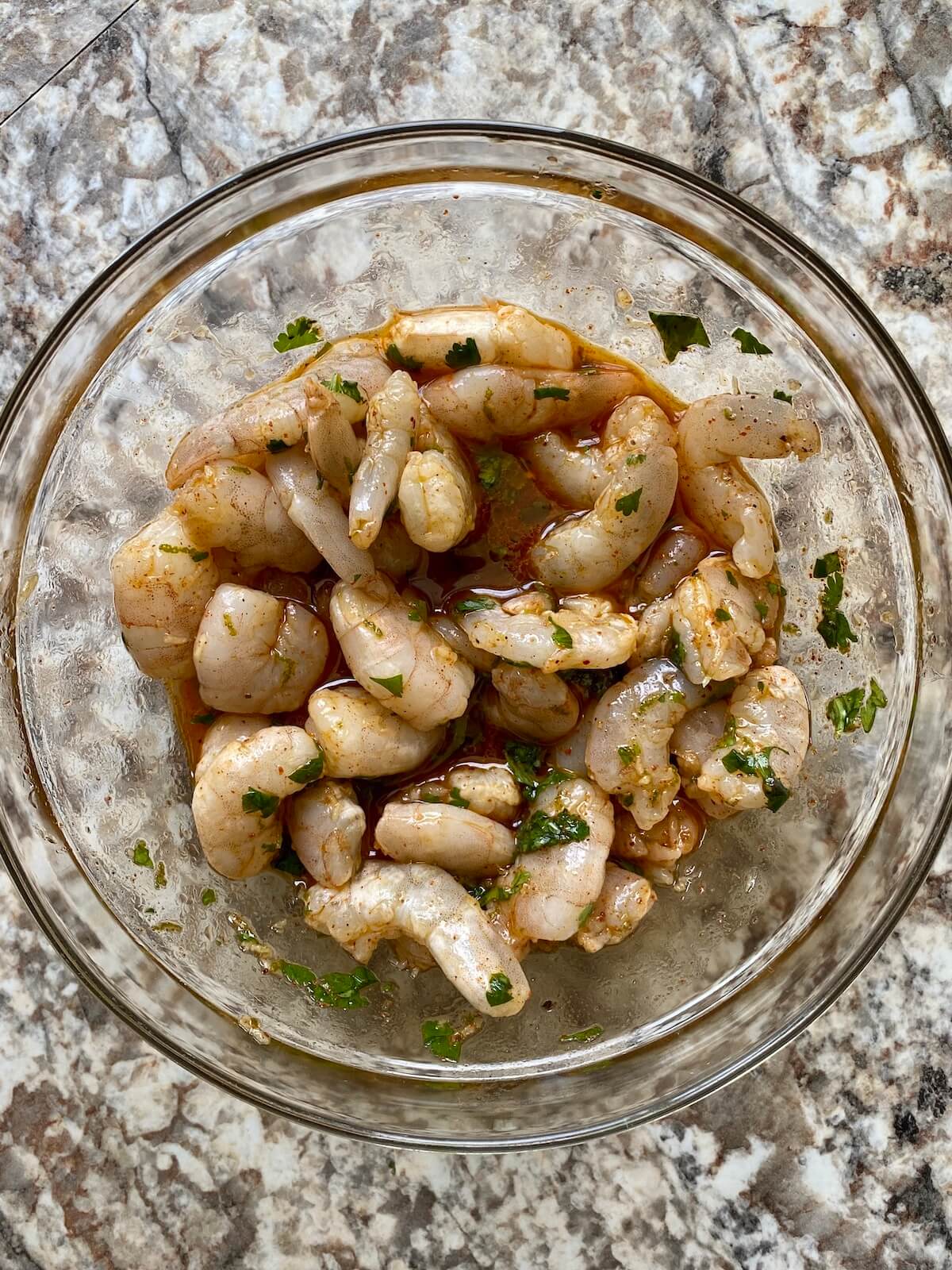 A bowl of shrimp marinating in tequila lime marinade.