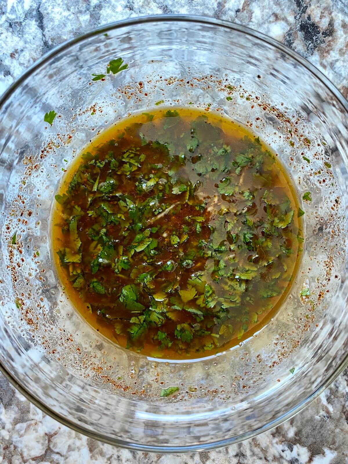A clear bowl with tequila lime marinade.