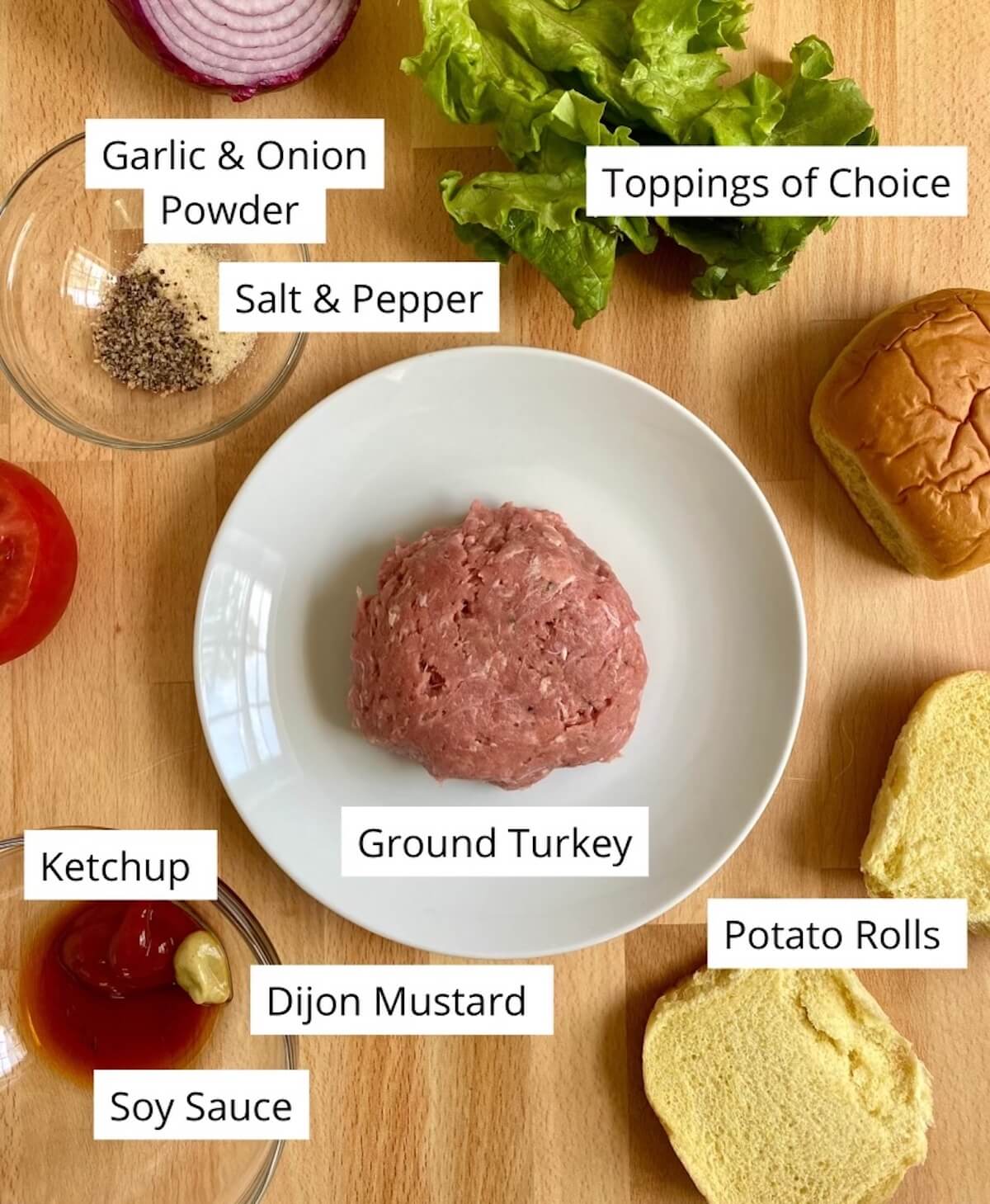 All of the ingredients to make turkey smash burgers being displayed on a countertop.