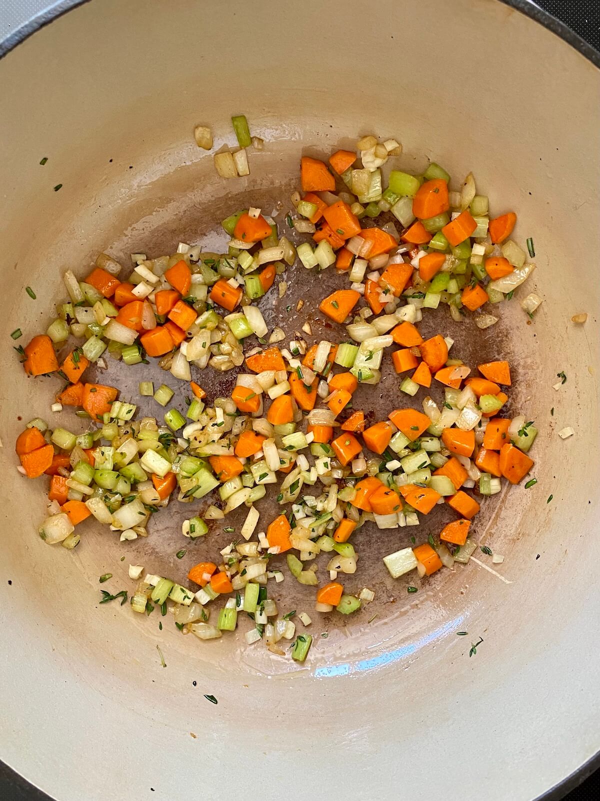 The mirepoix and aromatics being sautéed in the dutch oven.