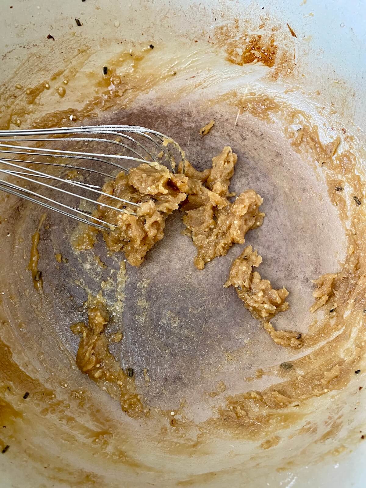A roux made from the braising liquid and flour being whisked in the bottom of a dutch oven.