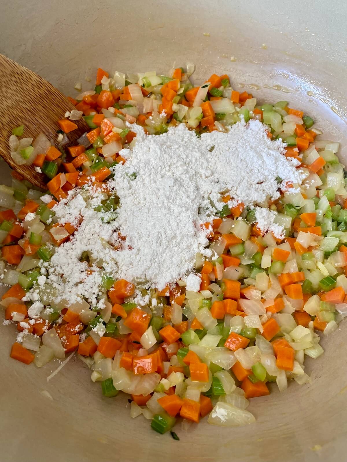 Flour sprinkled on top of the cooked vegetables to create a roux with the butter.