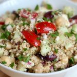A white bowl filled with Mediterranean ancient grain salad.