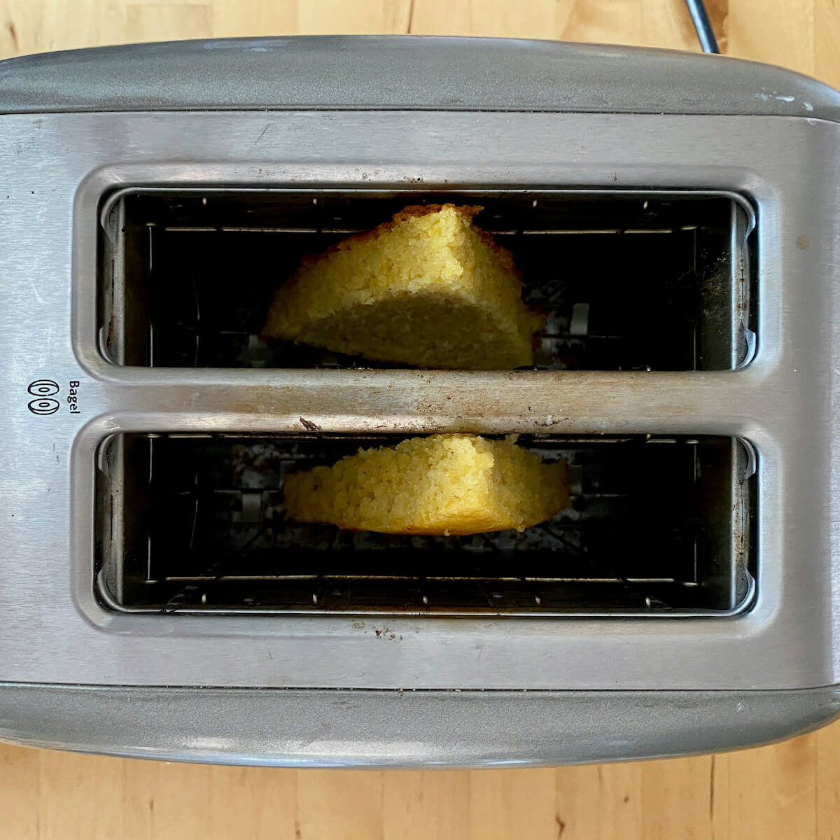 Two slices of cornbread in a toaster.