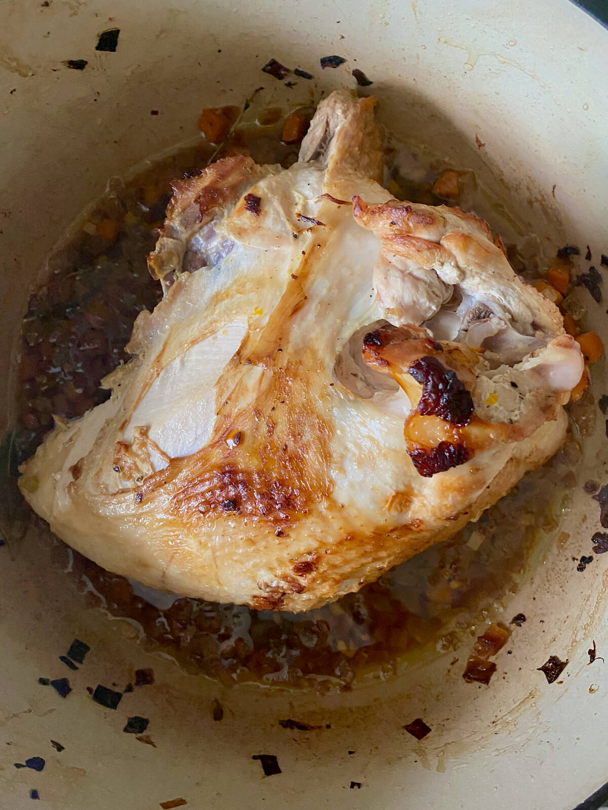 A braised turkey breast that has been cooked inside of a dutch oven.