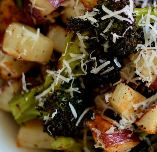 A bowl filled with parmesan roasted potatoes and broccoli.