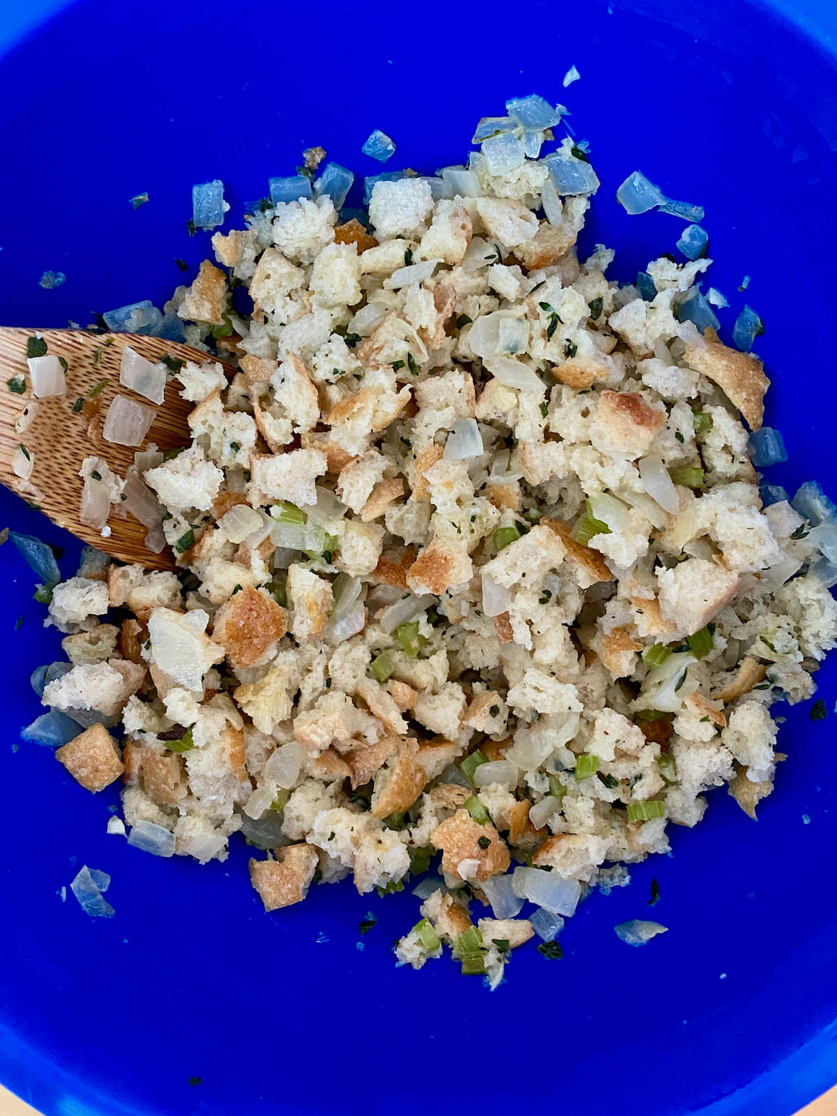 The finished stuffing mixture in a blue mixing bowl.