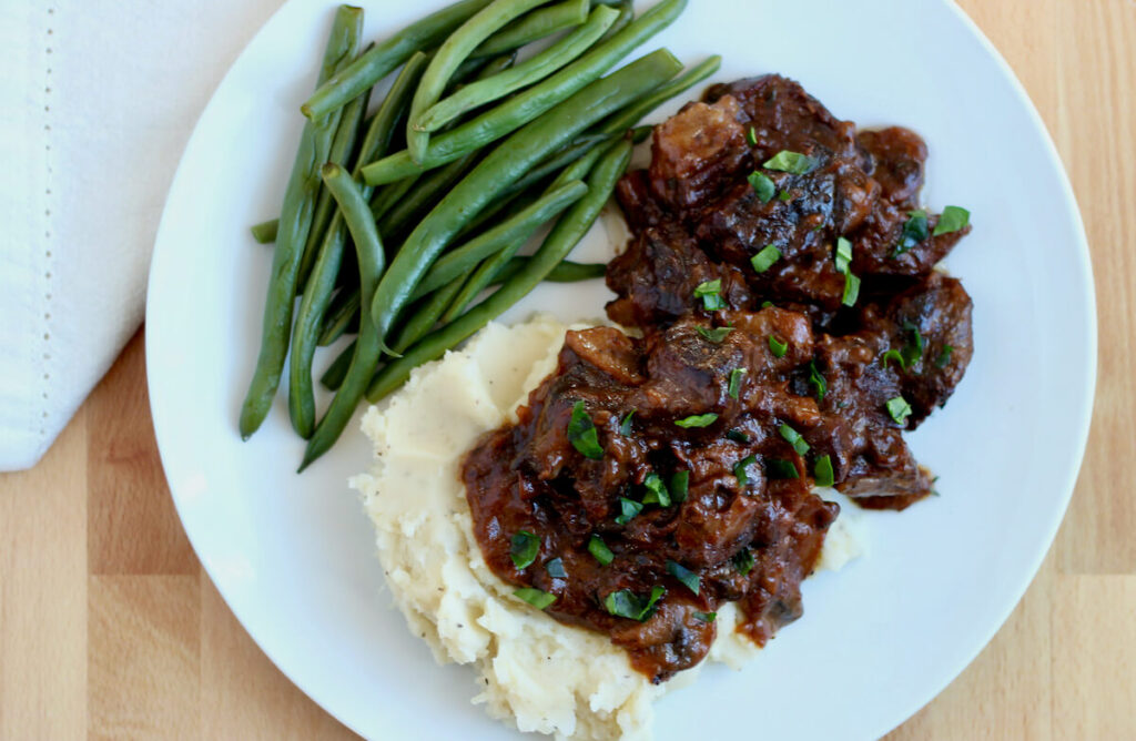 Image showcasing Braised Dutch Oven Steak with Mushroom Gravy - Everyday Homemade