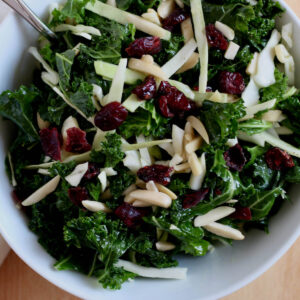 A white bowl filled with kale crunch salad.