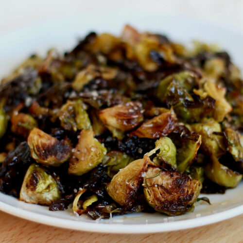 Maple balsamic brussels sprouts on a white plate.