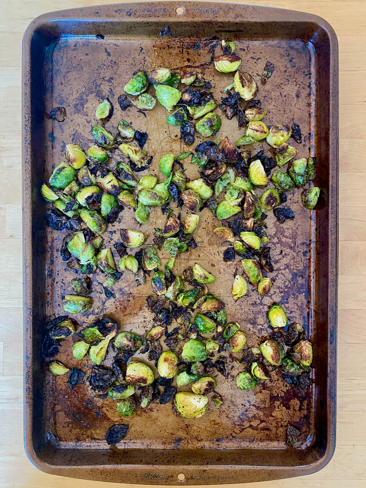 Roasted brussels sprouts on a rimmed baking sheet.