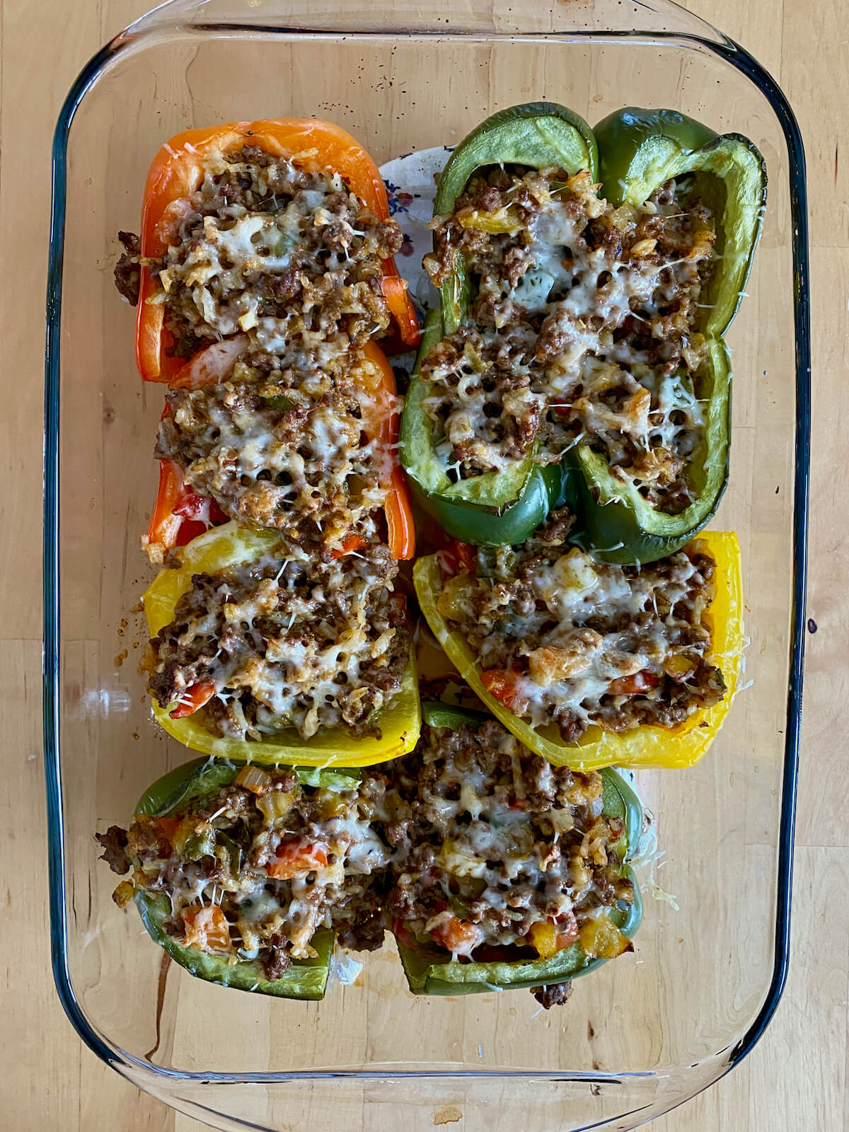 Baked stuffed peppers in a casserole dish.
