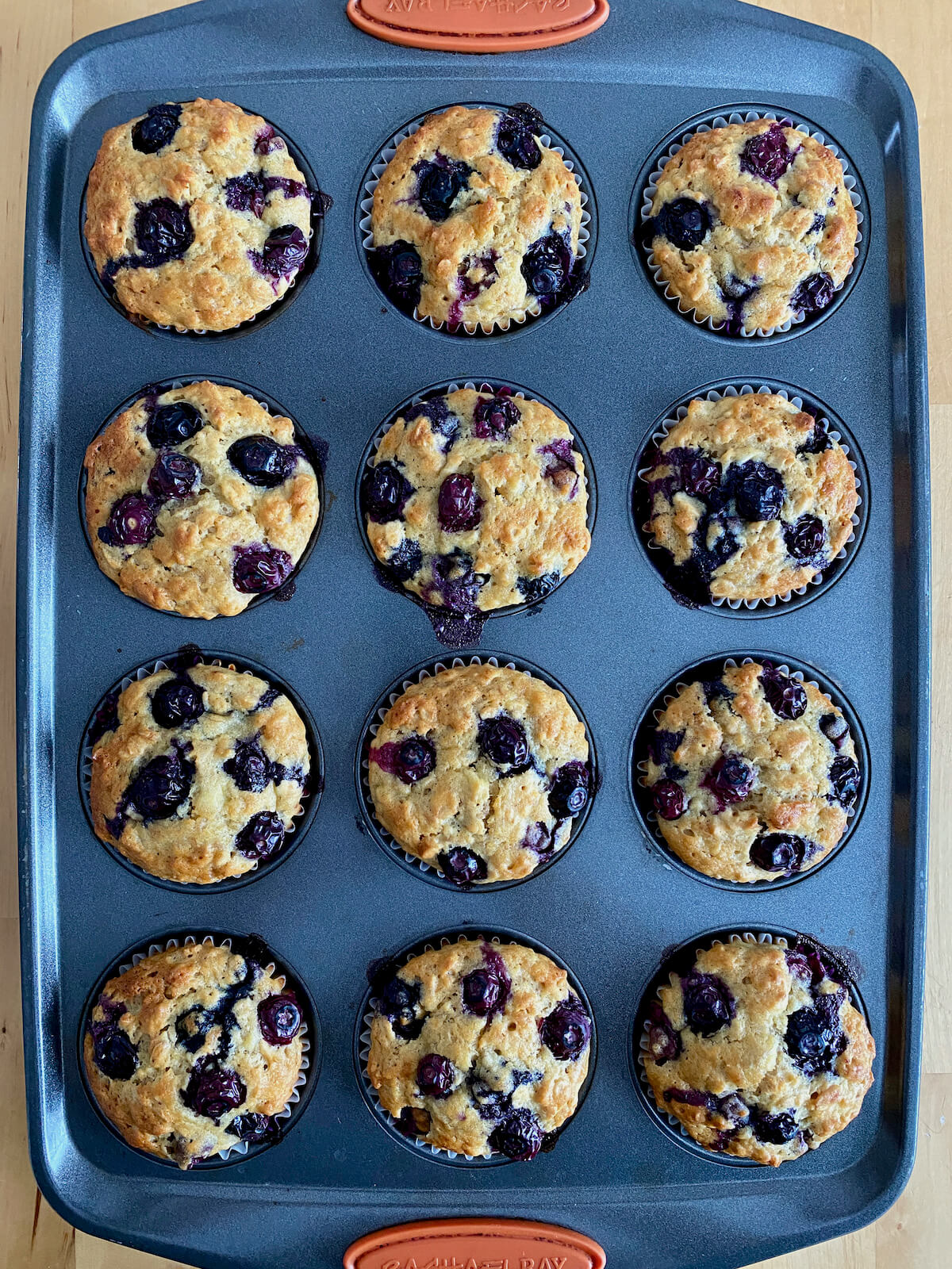 The finished blueberry banana oatmeal muffins in a muffin tin.