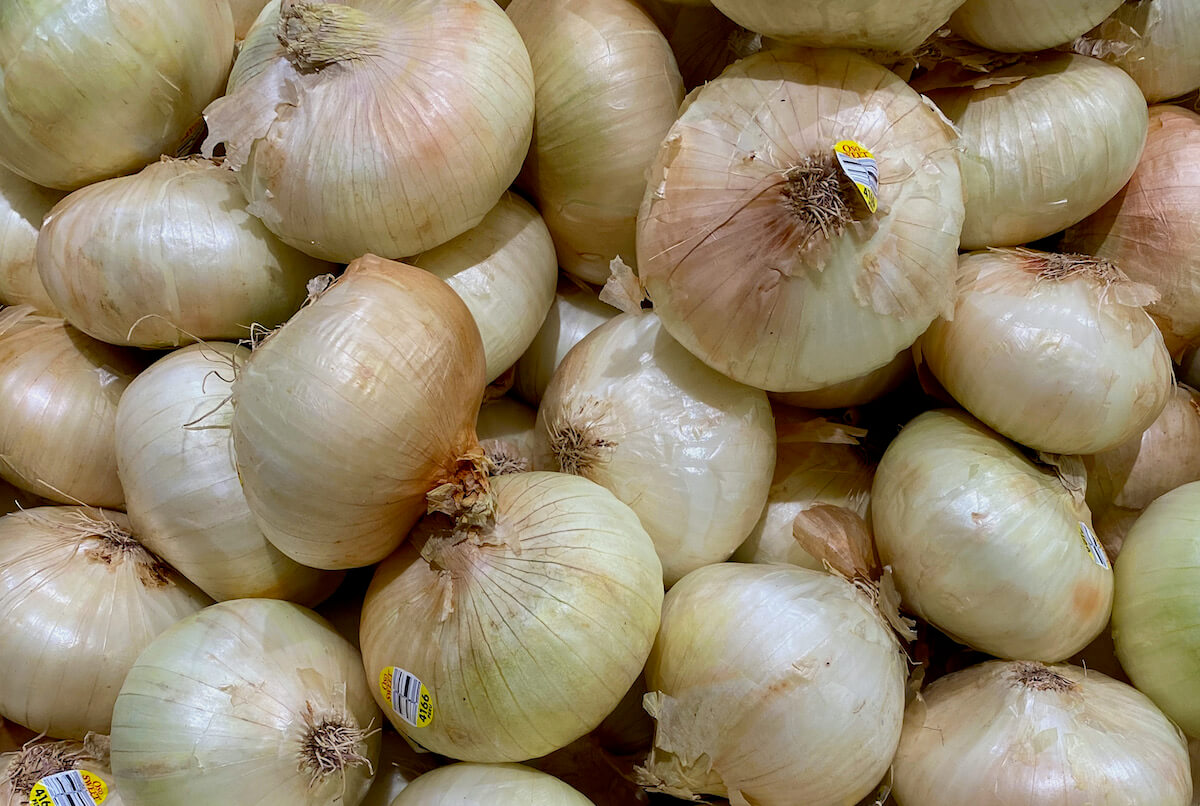 A bunch of sweet onions at the grocery store.