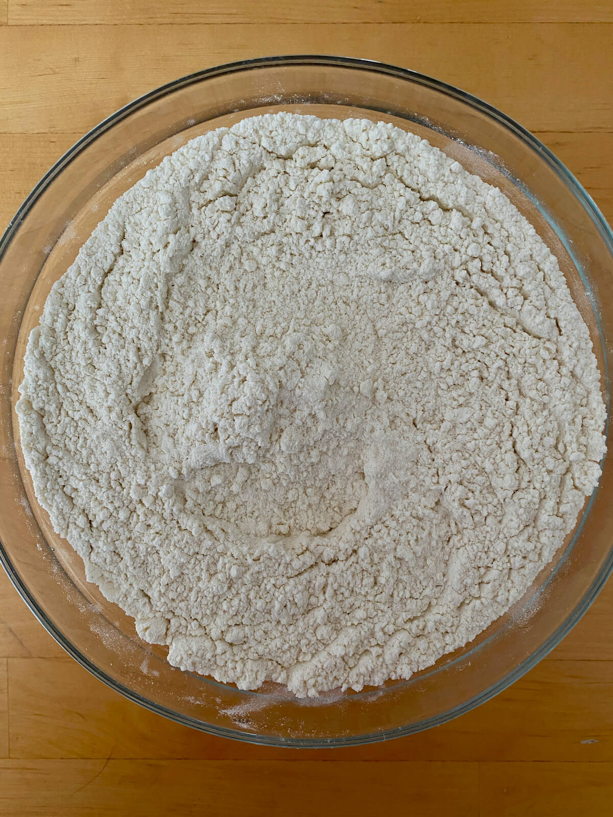 The dry ingredients in a glass mixing bowl.