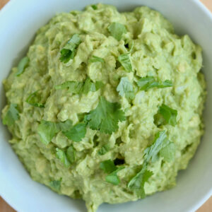 A bowl of 4-ingredient guacamole garnished with cilantro.