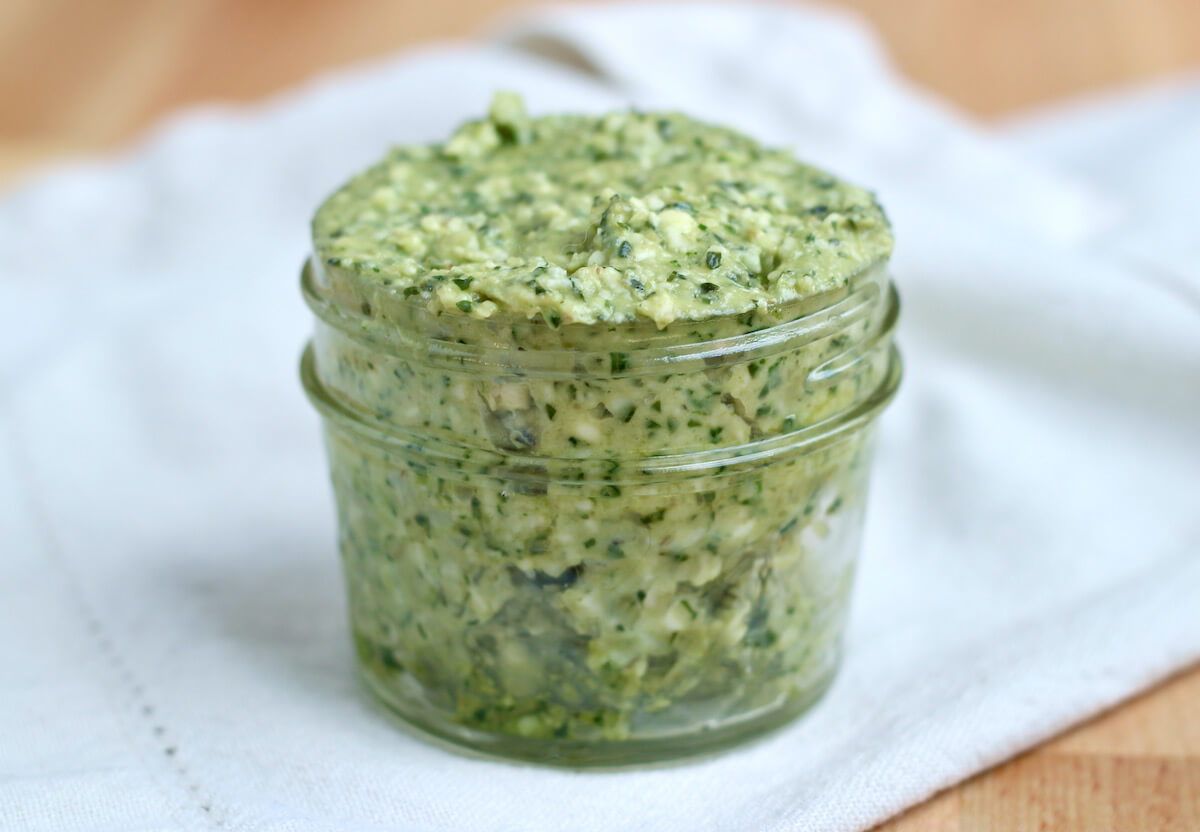 A small mason jar filled with pesto butter.
