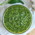 Pesto without pine nuts in a small glass bowl.