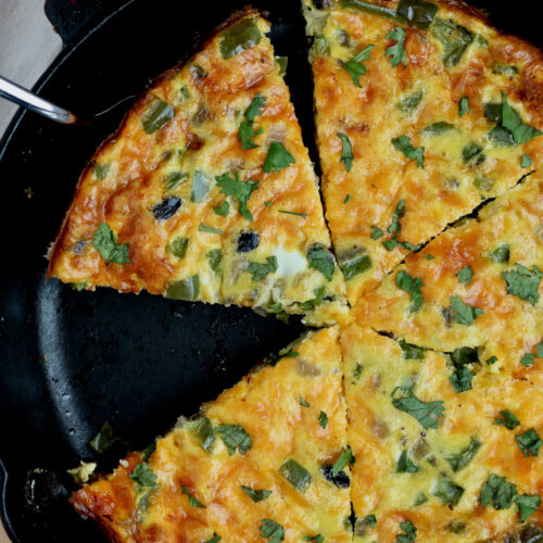 A sliced southwestern frittata in a cast iron skillet.