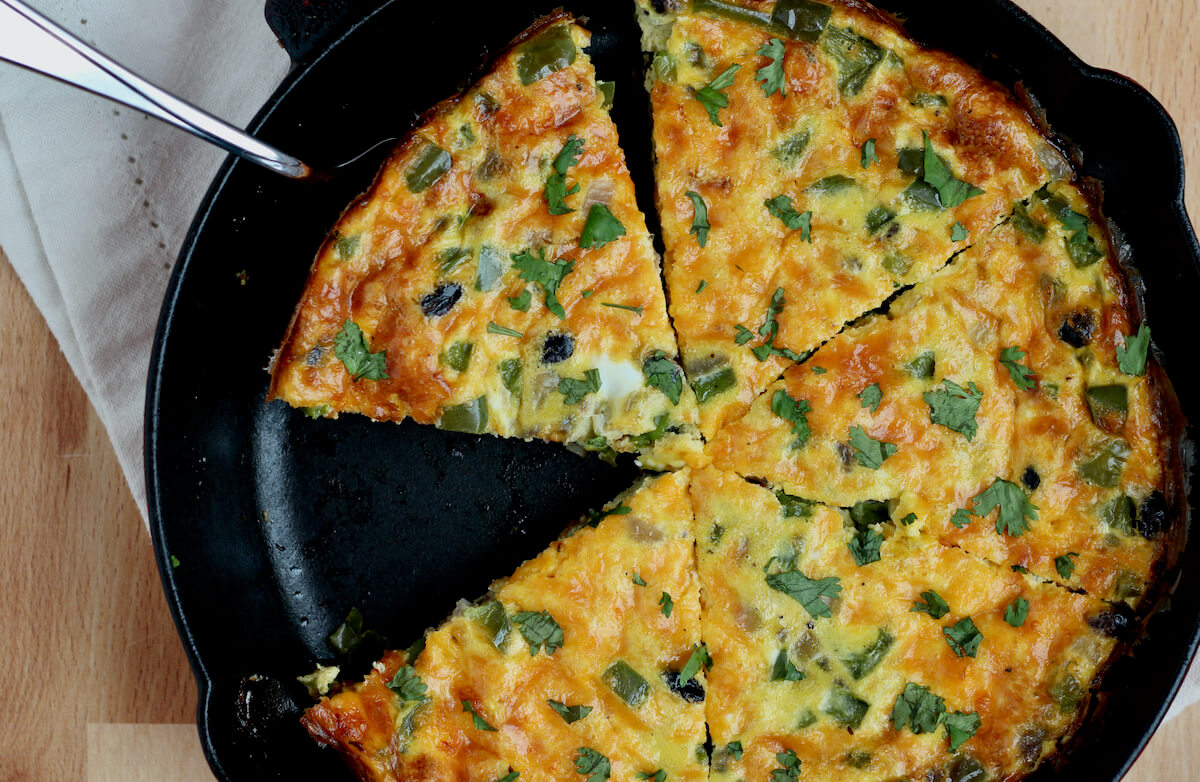 A sliced southwestern frittata in a cast iron skillet.