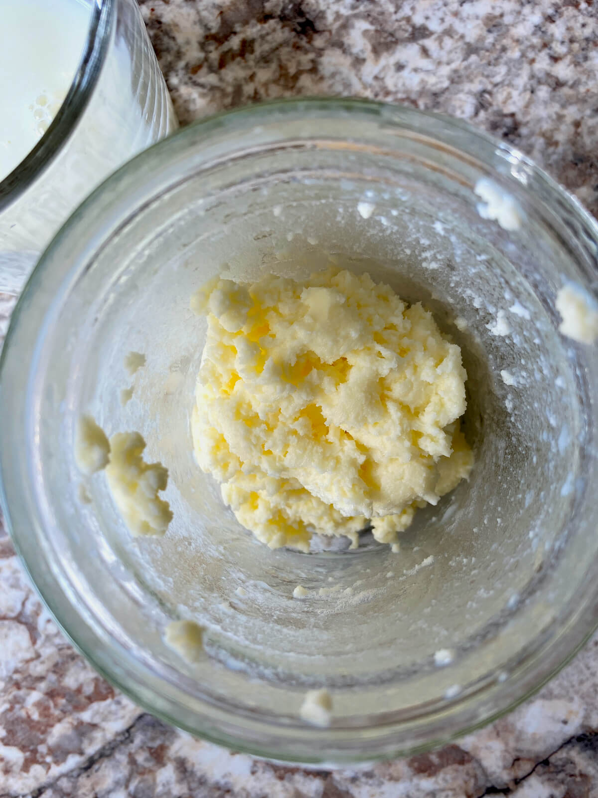 Butter in a glass mason jar after pouring off the buttermilk.