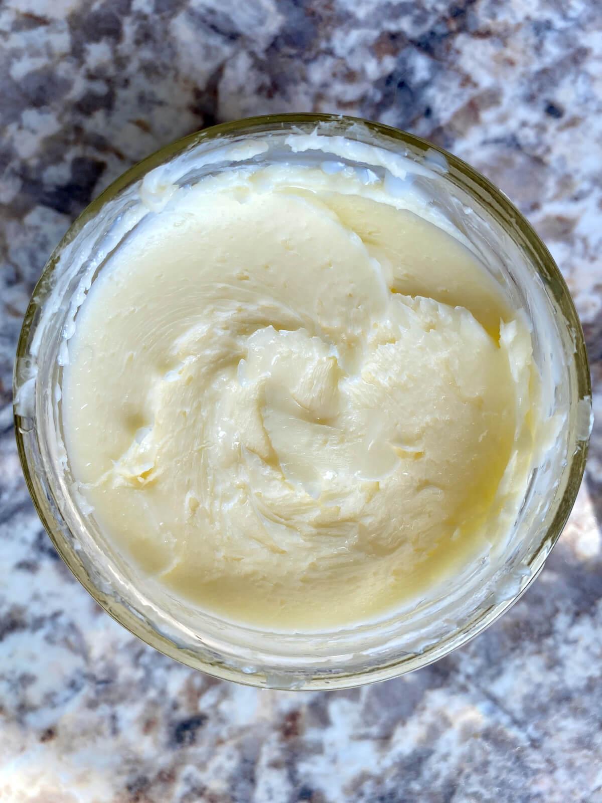 Homemade butter in a small glass mason jar.