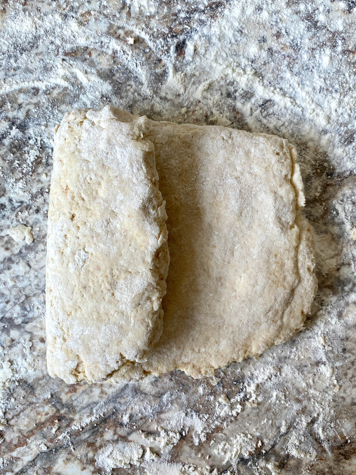The biscuit dough rectangle with one side folded into the middle.