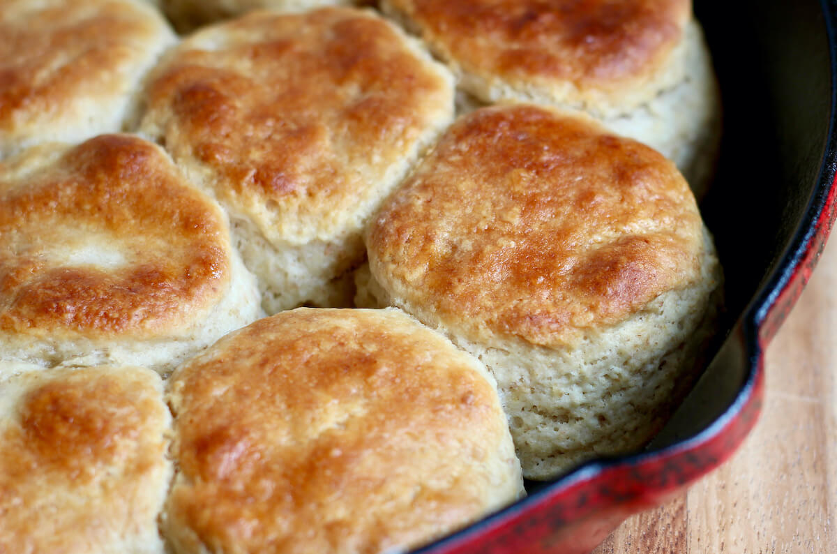 Sourdough discard biscuits in a red cast iron skillet.