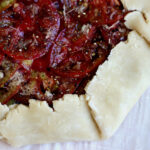 An unbaked tomato galette made with 3 ingredient pie crust.
