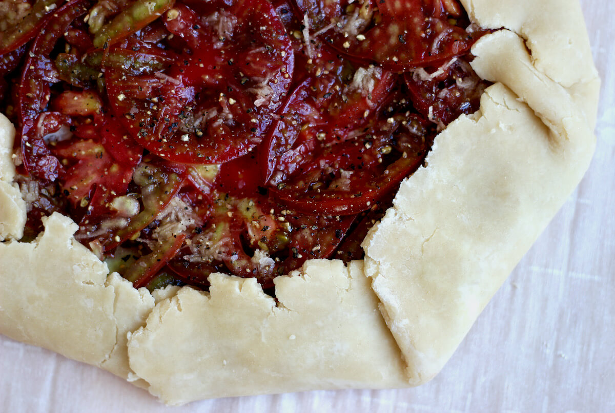 An unbaked tomato galette made with 3 ingredient pie crust.