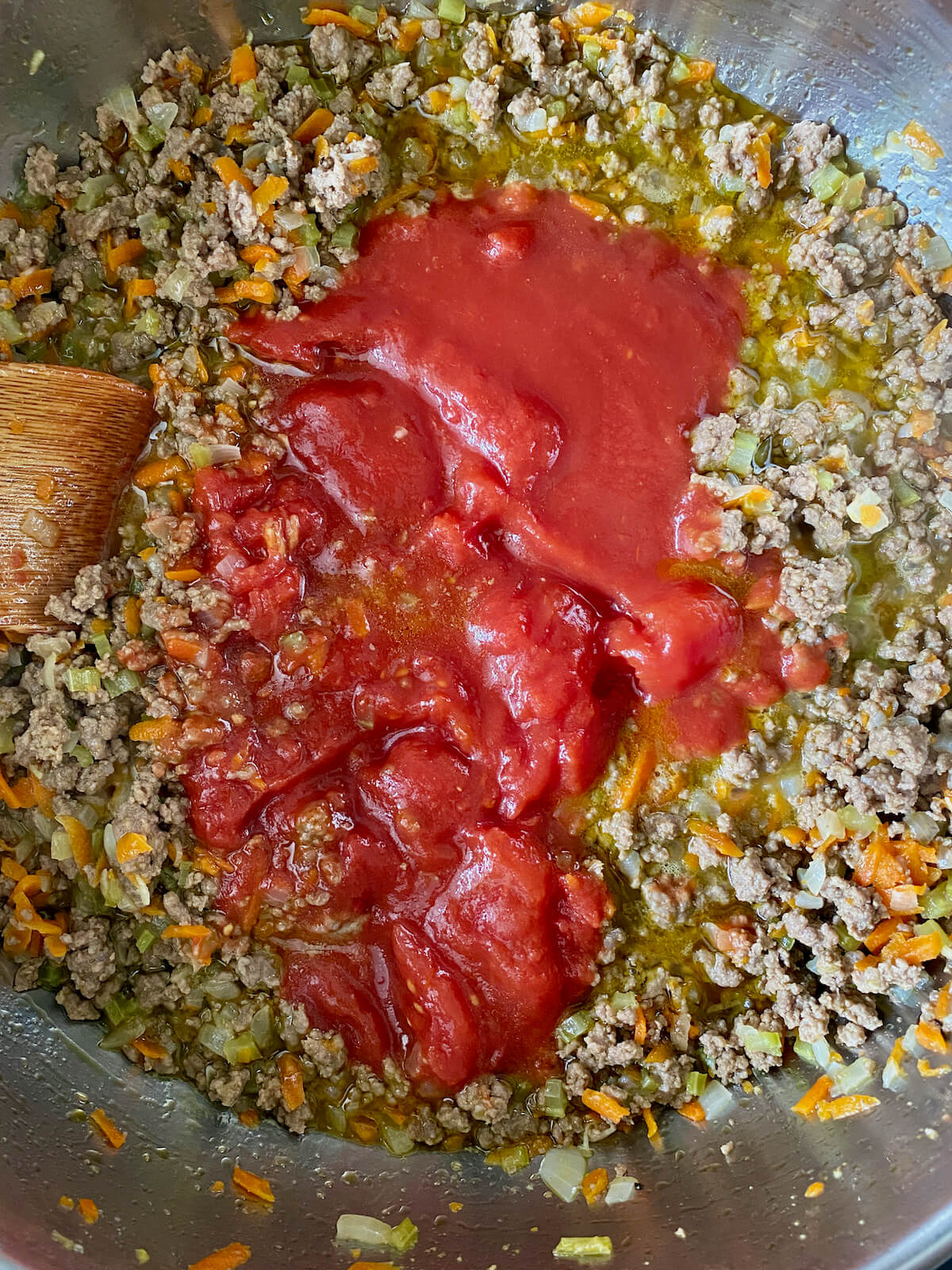 Whole peeled San Marzano tomatoes added to the ground beef mixture.