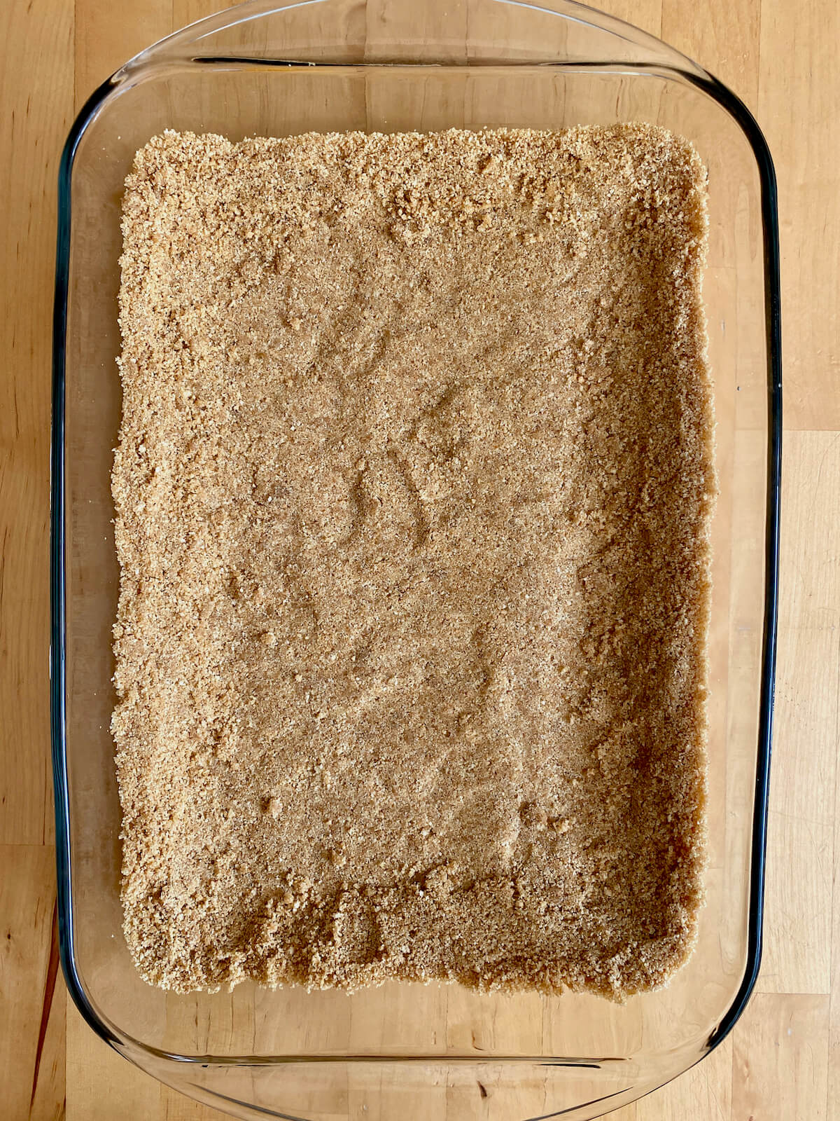 Graham cracker crust pressed into a glass 9 inch by 13 inch baking dish.