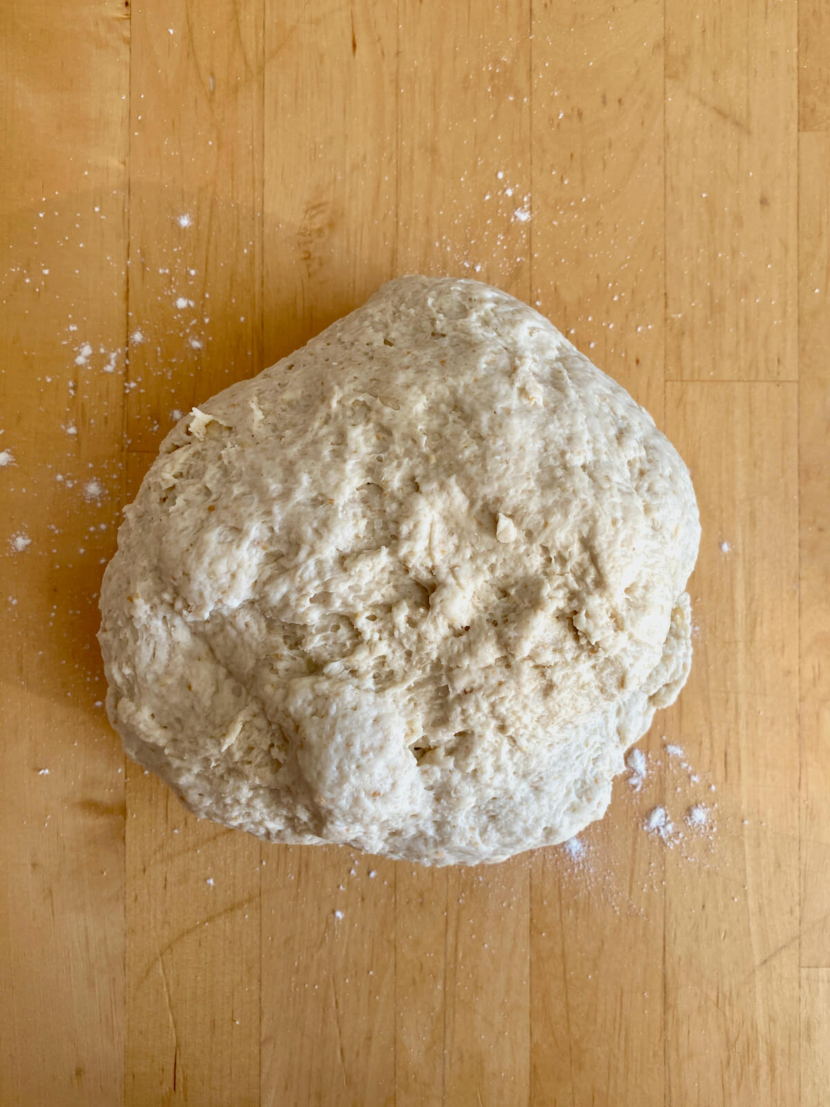 Sourdough soft pretzel dough on a lightly floured counter before being kneaded.