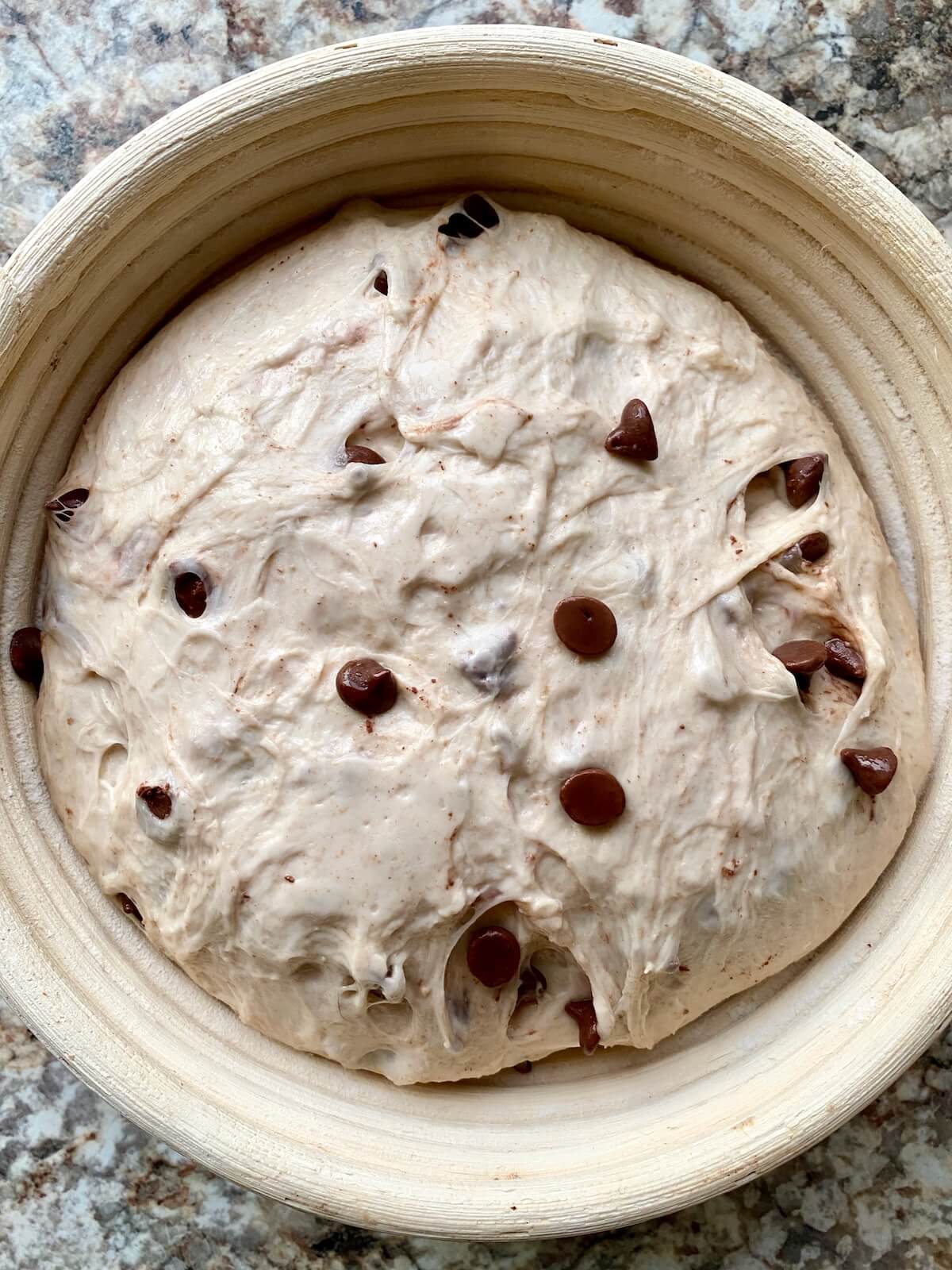 The dough in a banneton basket after proofing overnight.