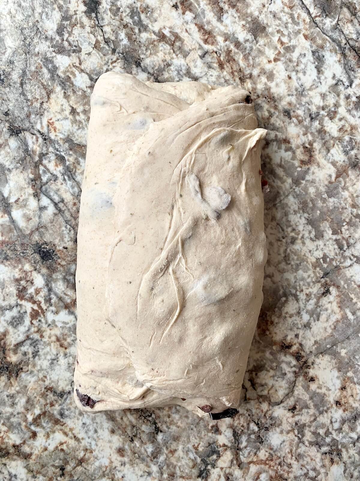 The dough folded in thirds like a letter on a floured countertop.