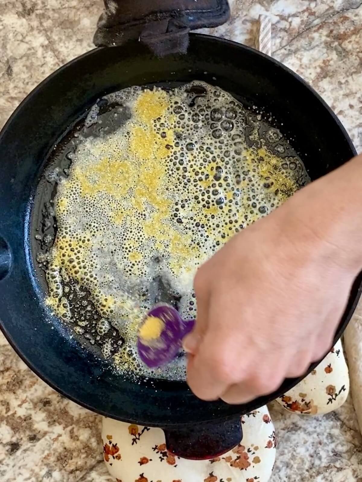 A hot cast iron skillet coated with melted butter and cornmeal.