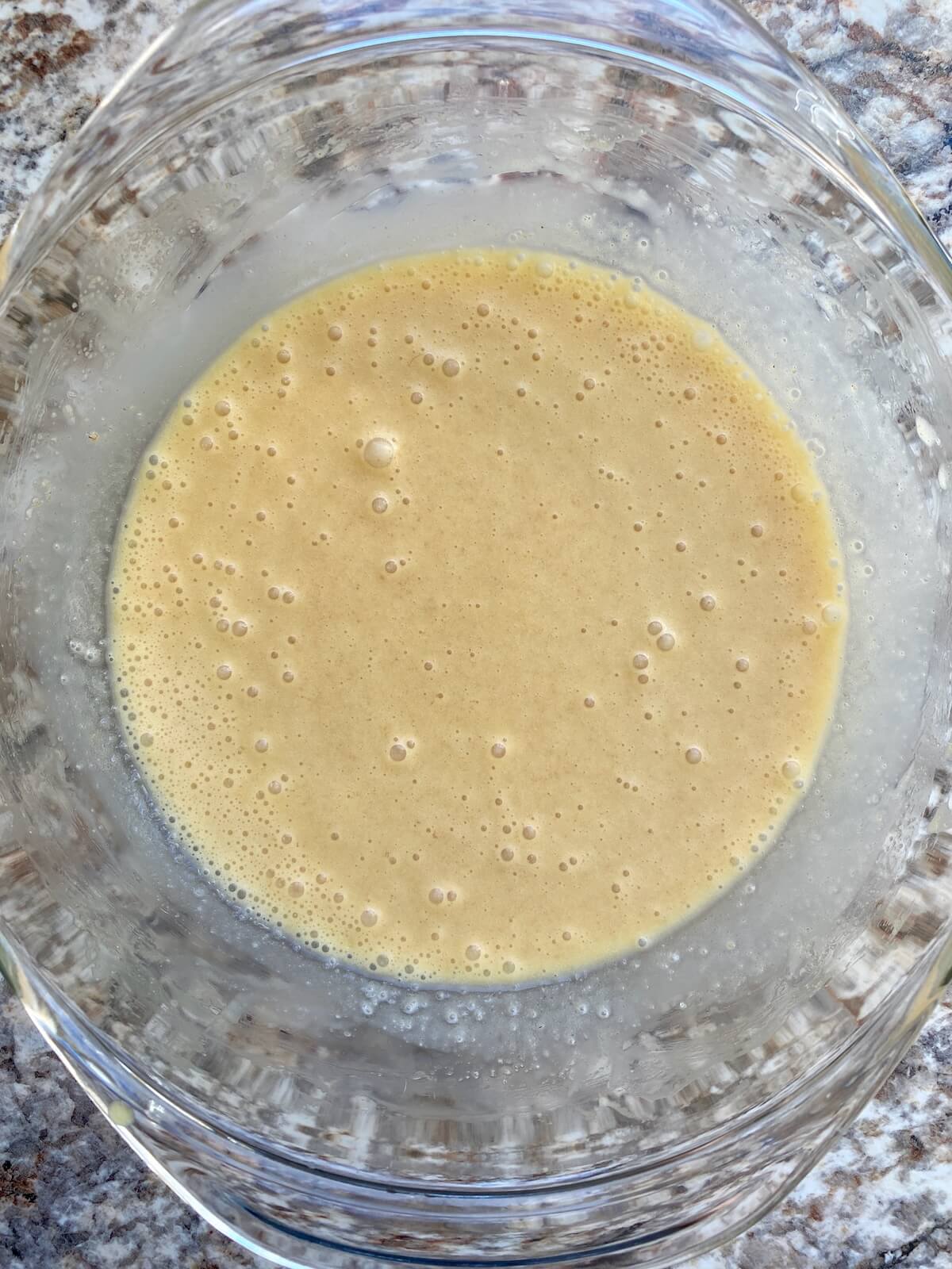 The wet ingredients mixed together in a glass bowl.