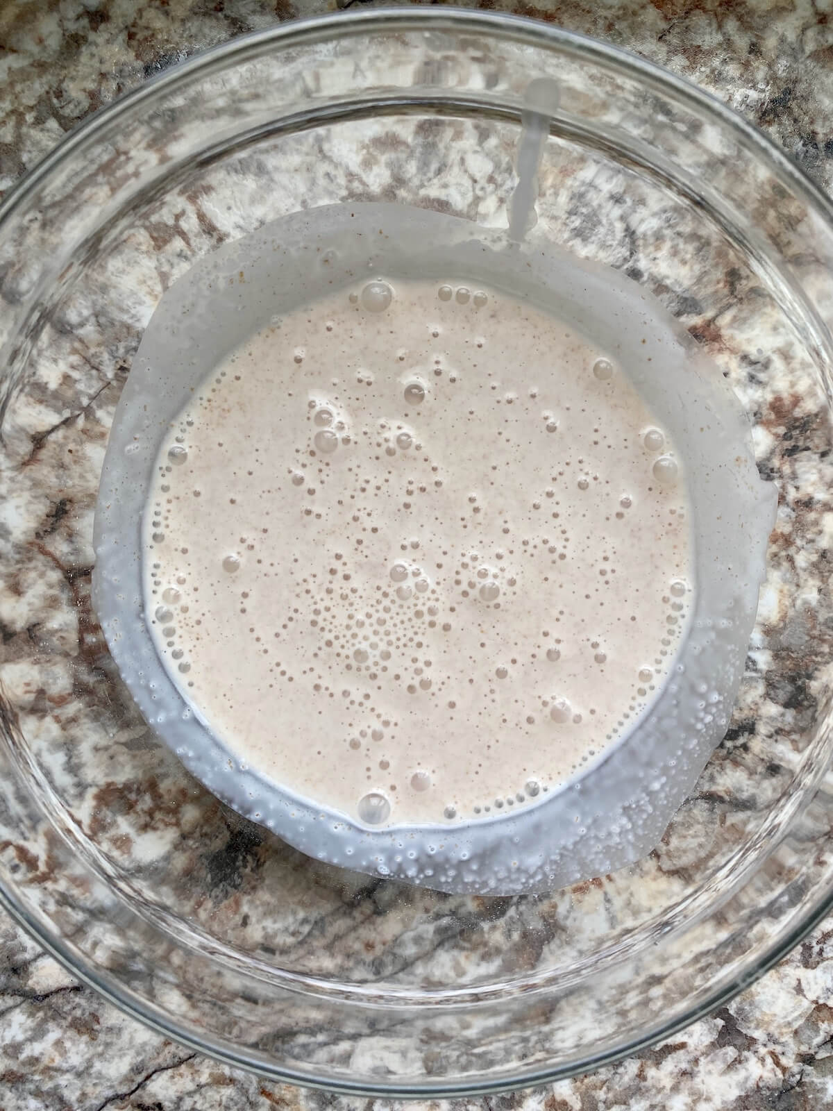 Heavy cream, whole milk, and sourdough discard mixed together in a glass bowl.