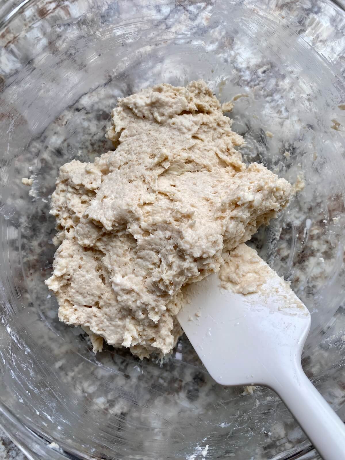 Sourdough drop biscuit batter in a glass bowl.