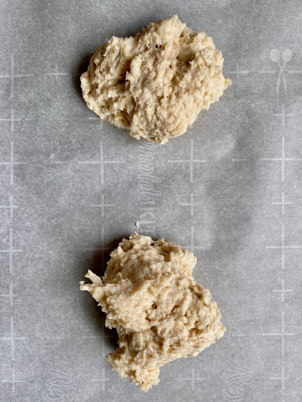 Sourdough drop biscuit batter on a parchment-lined baking sheet.