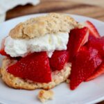 Sourdough strawberry shortcake on a small white plate.
