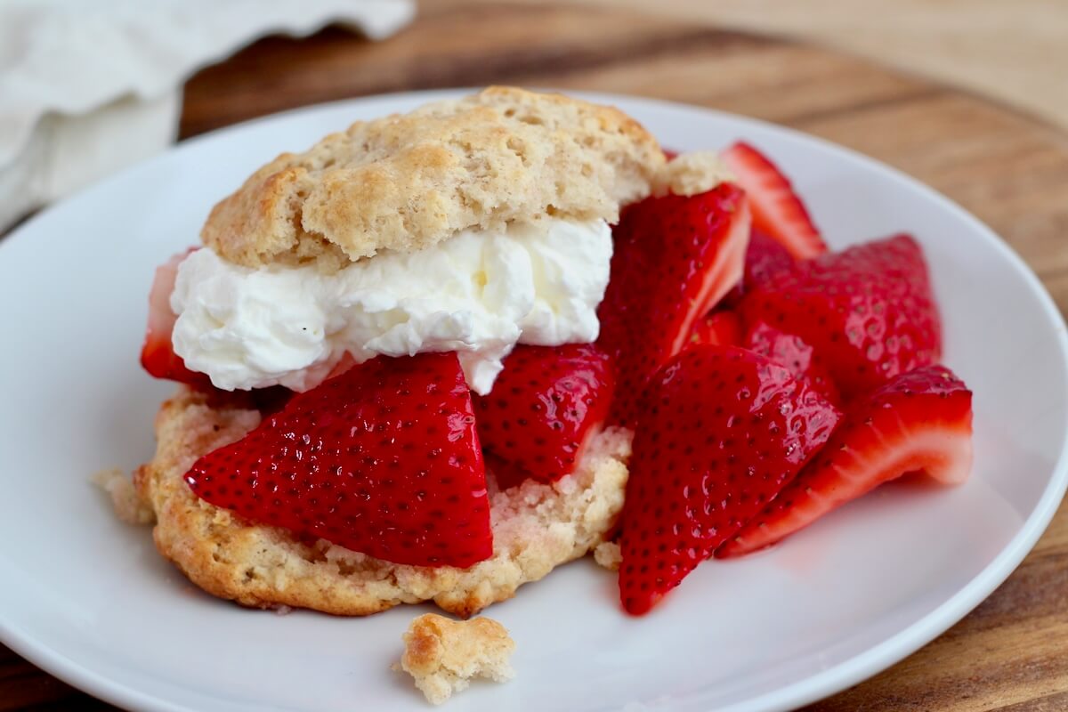 Sourdough strawberry shortcake on a small white plate.