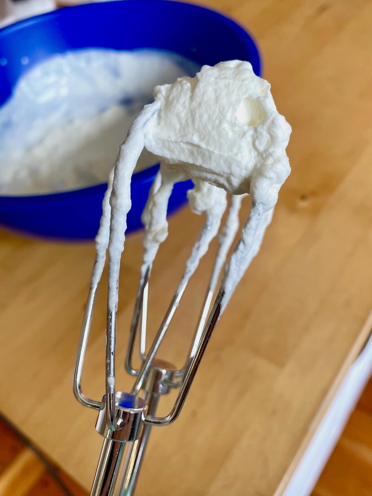 Homemade whipped cream on a beater.