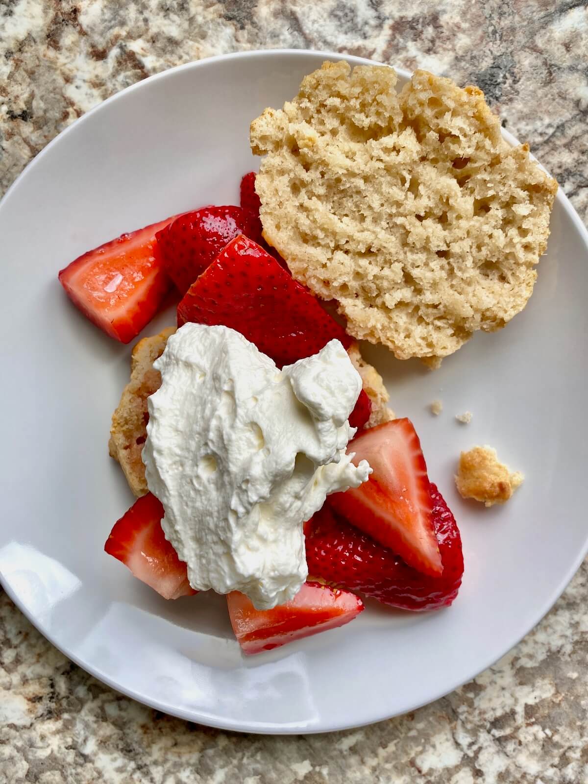 A small white plate with sourdough strawberry shortcake.