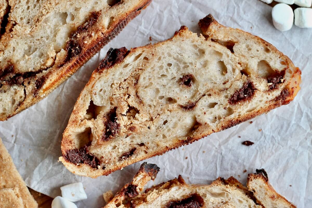 Slices of s'more sourdough bread on a piece of parchment paper.