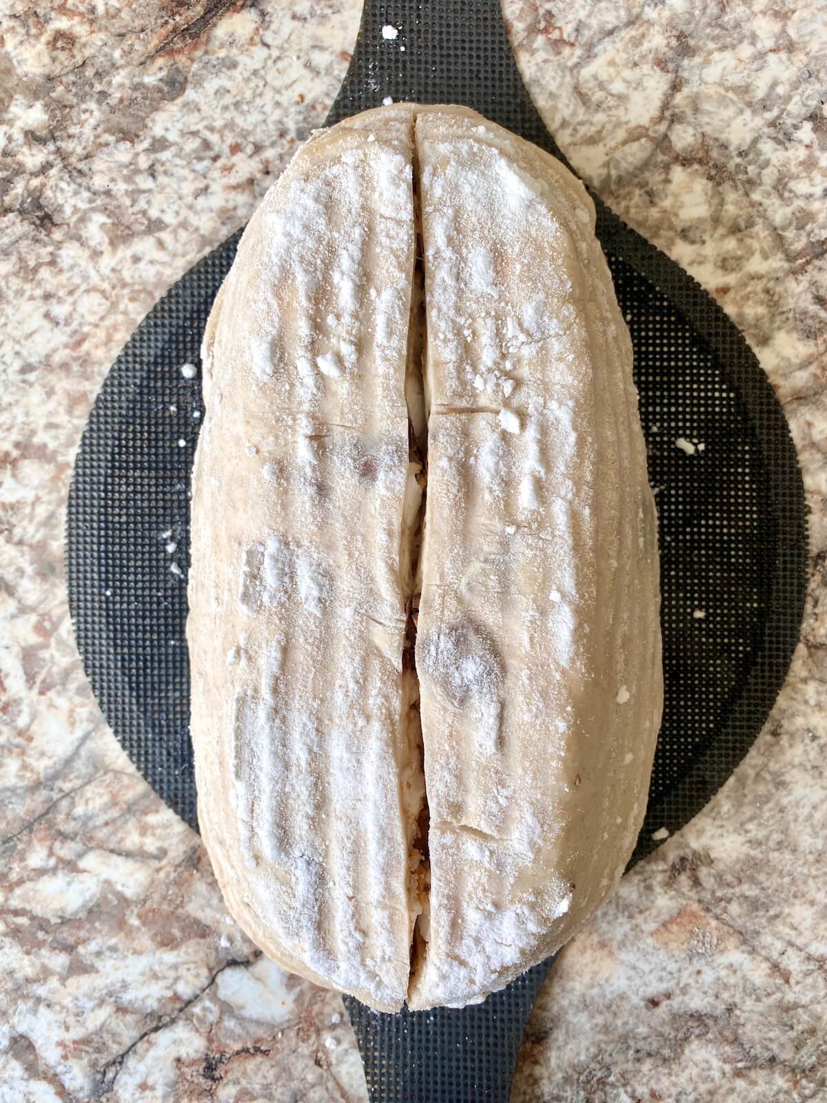 S'mores sourdough bread dough scored on a bread sling before baking.