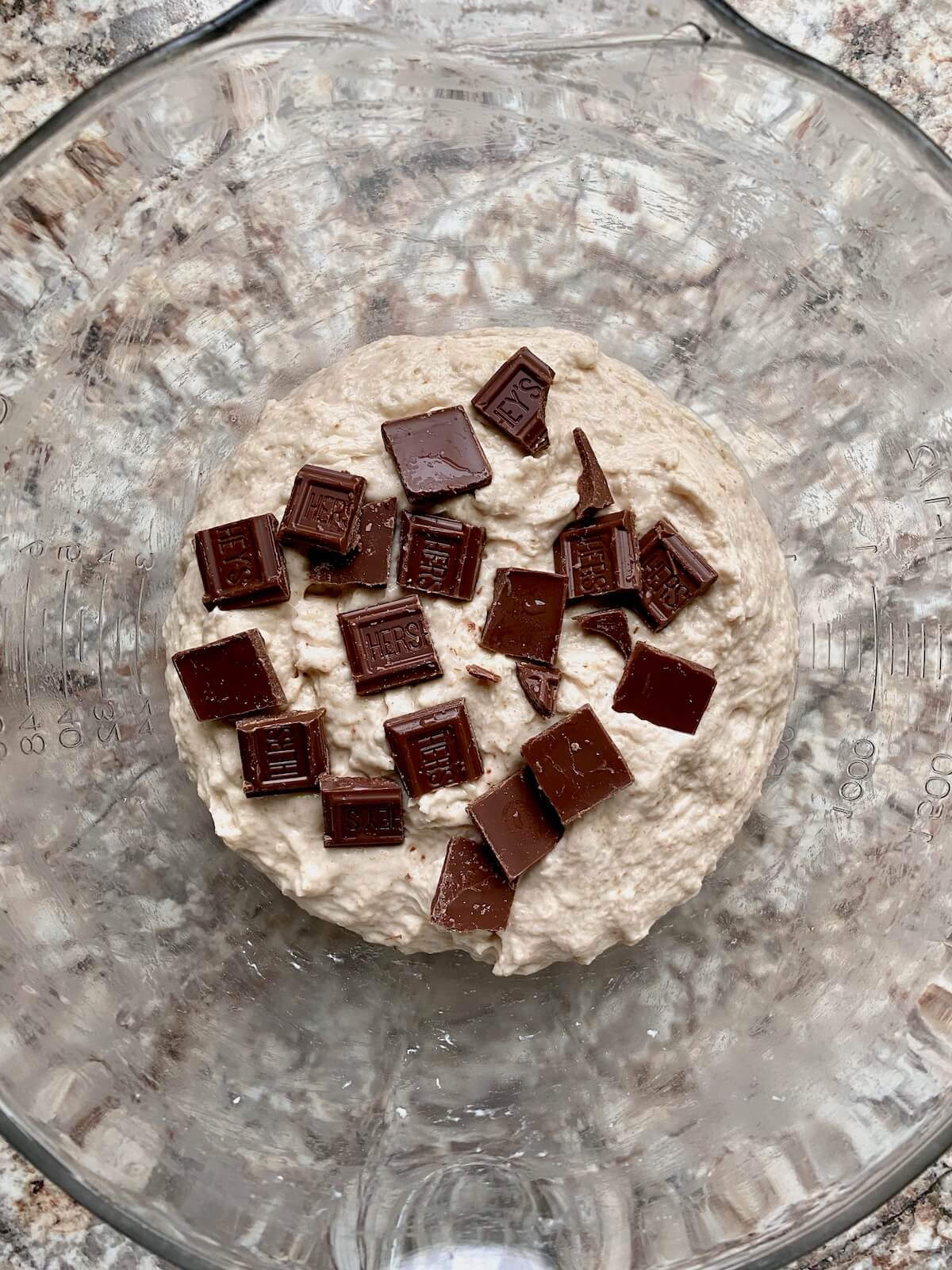 Sourdough bread dough topped with pieces of Hershey's chocolate bar.