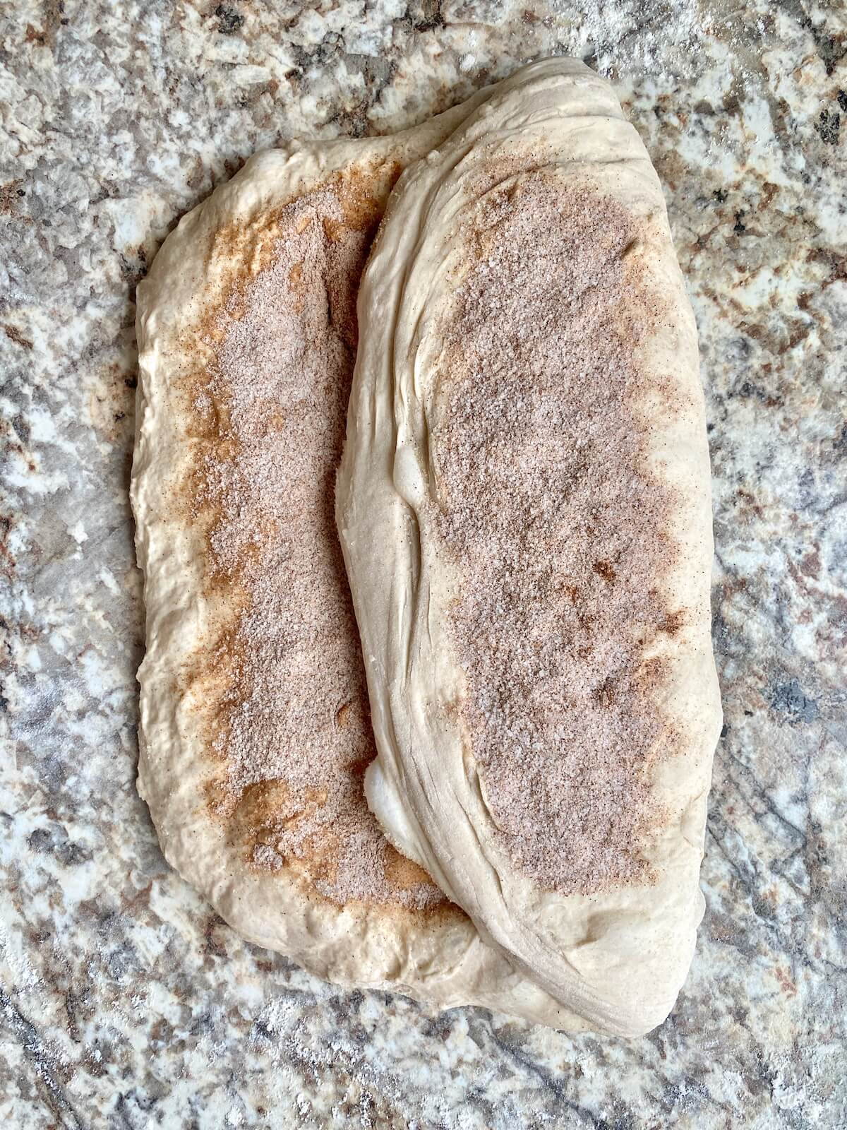 Cinnamon sugar being incorporated into the dough as it's being shaped.